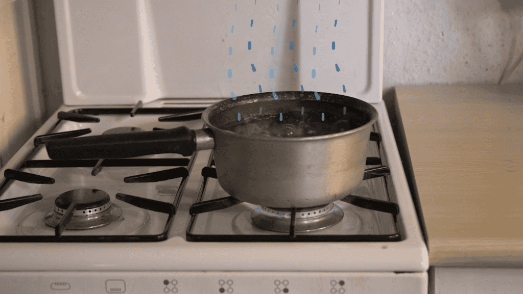 A saucepan on a gas hob boiling water with animated water particles raising up from the pot