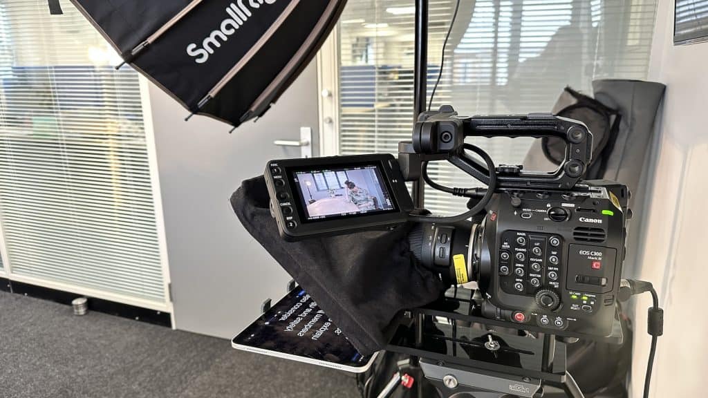 Side view of Canon C300 camera with autocue as part of a corporate video filming session