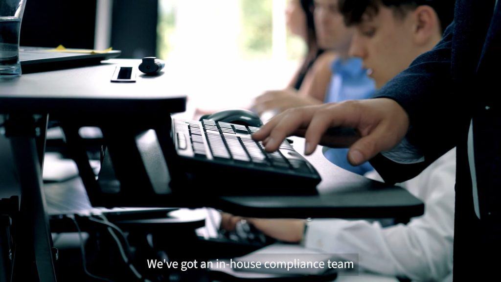 close up of hands typing on a standing desk in an office