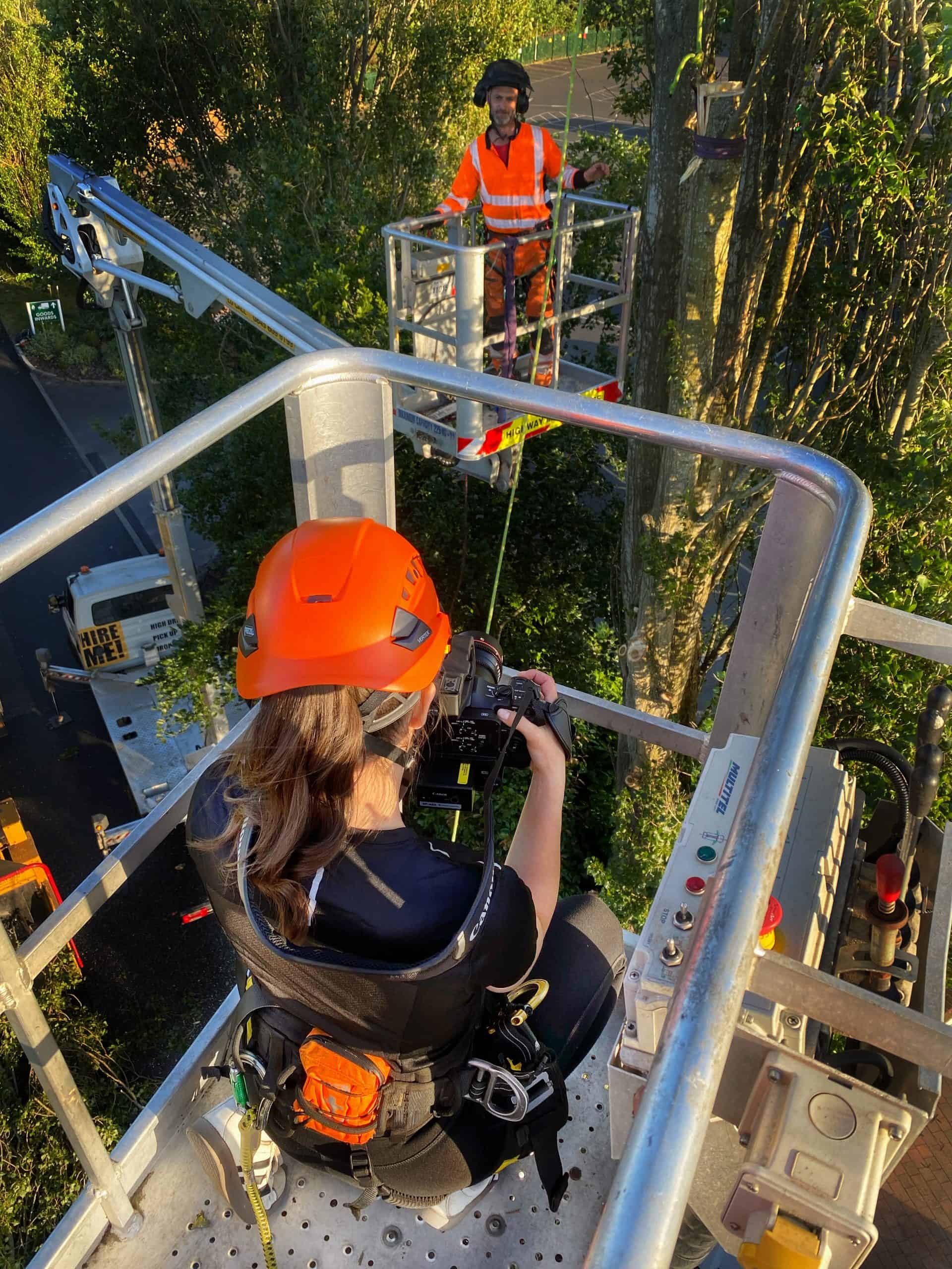 woman filming in a cherry picker