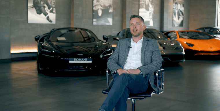 interview setup with luxury cars behind