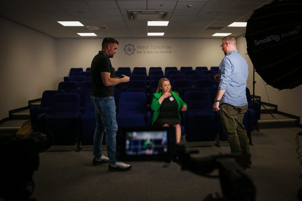 Behind the scenes pic of an interviewee being mic's up in the lecture hall at SYF&RS
