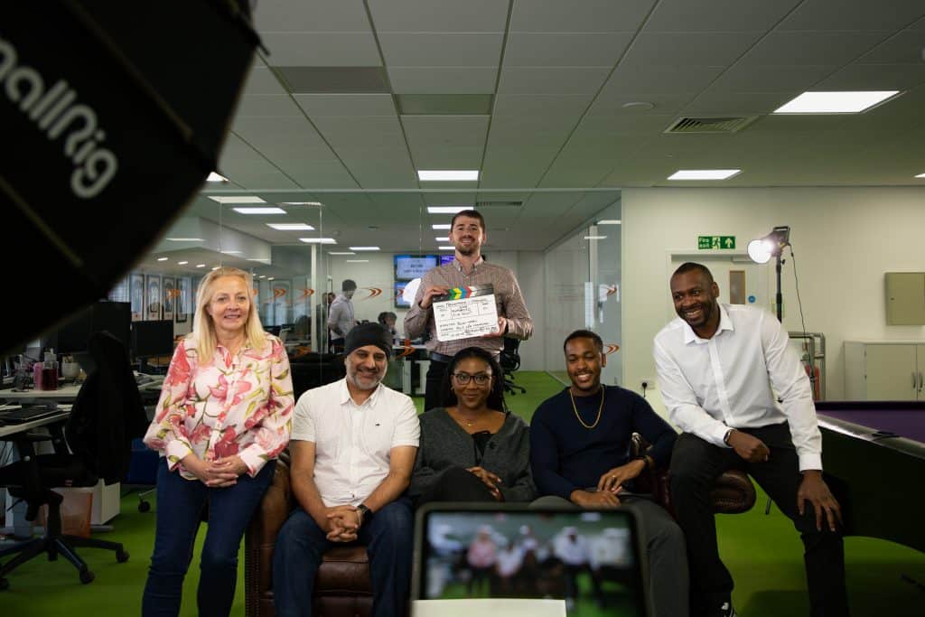 Croydon team sat on a sofa with clapperboard