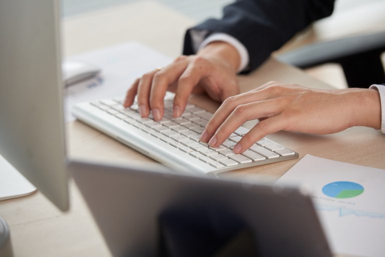 Hands typing on a keyboard