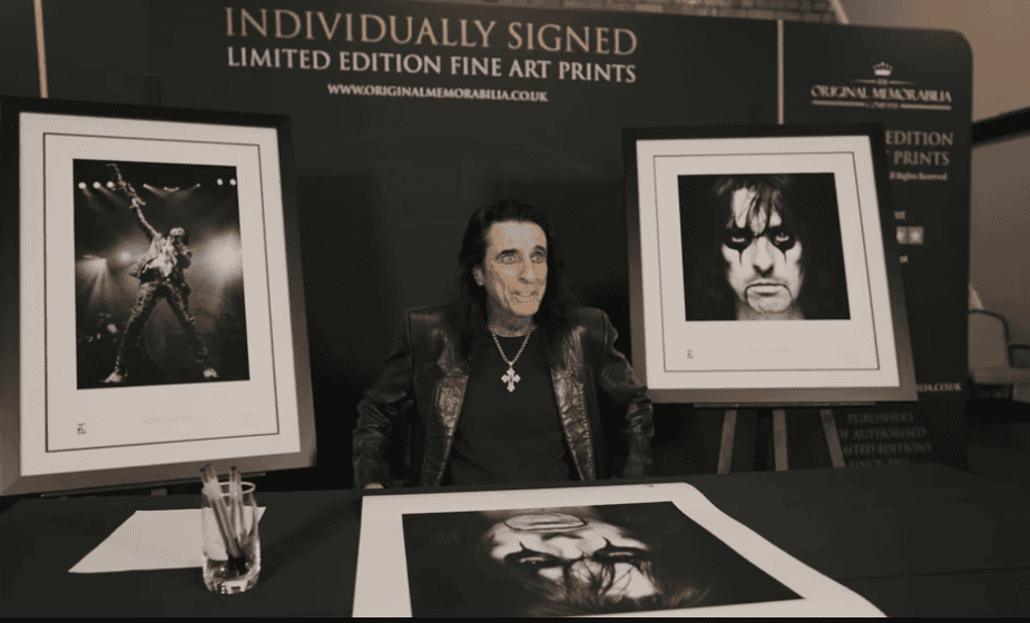 Alice Cooper signing prints at a filming session