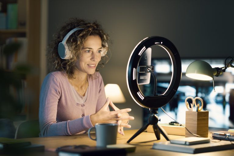 A DIY filming setup to show a ring light and the phone in a podcasting setup