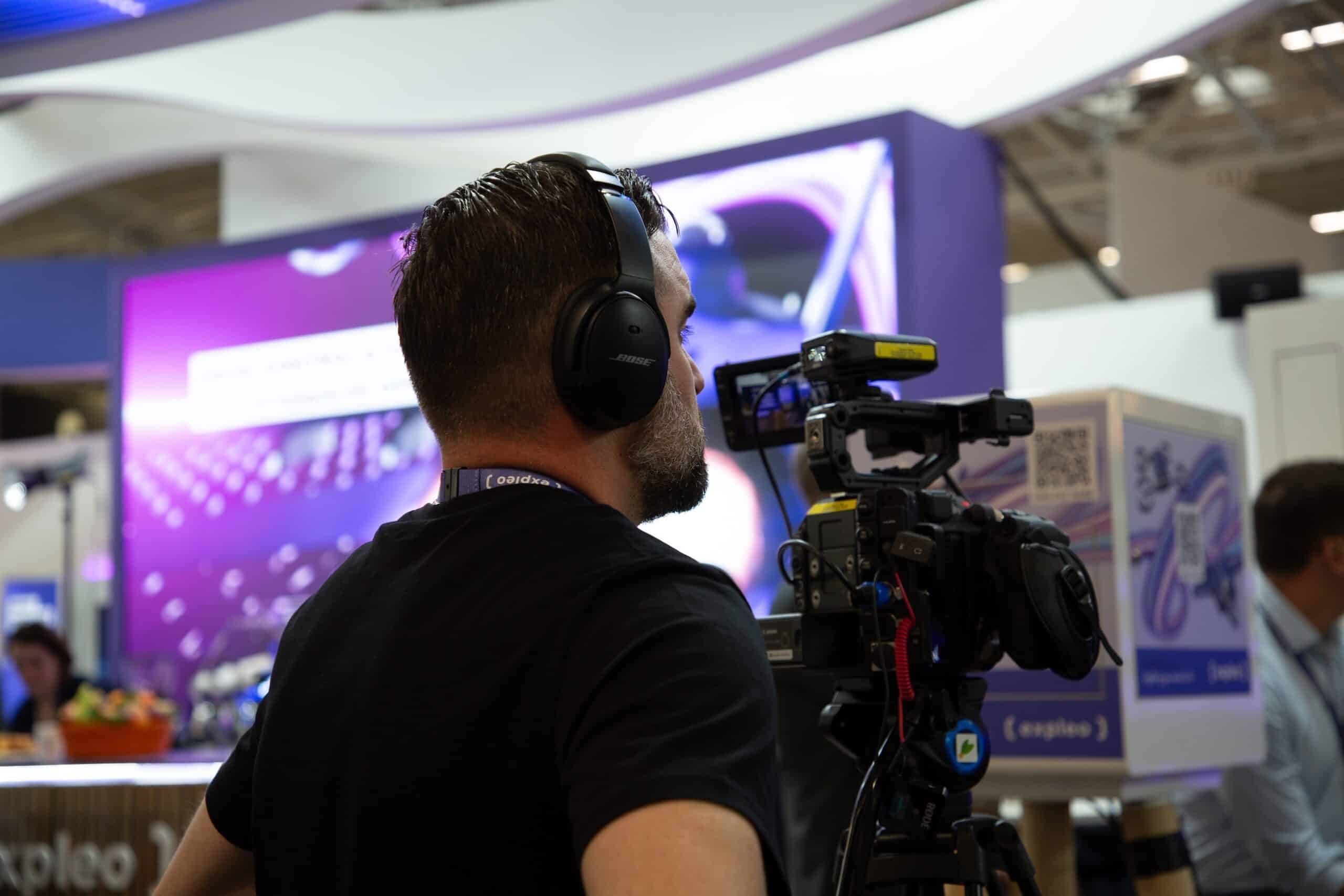 Cameraman capturing footage of an expo